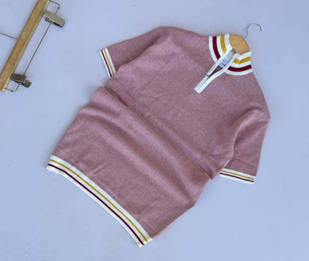 a pink, short-sleeved knit shirt