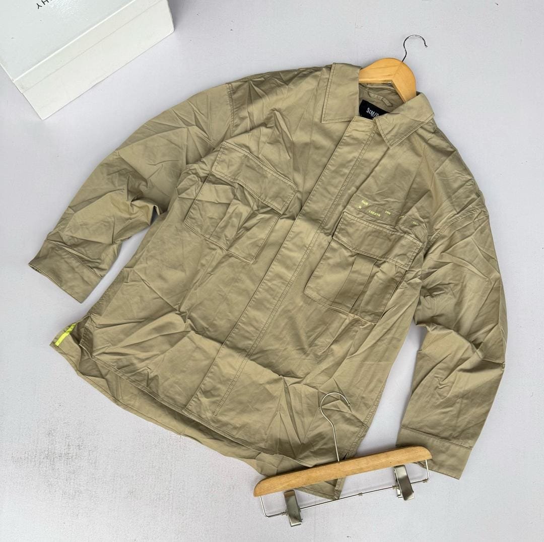 a beige, long-sleeved shirt