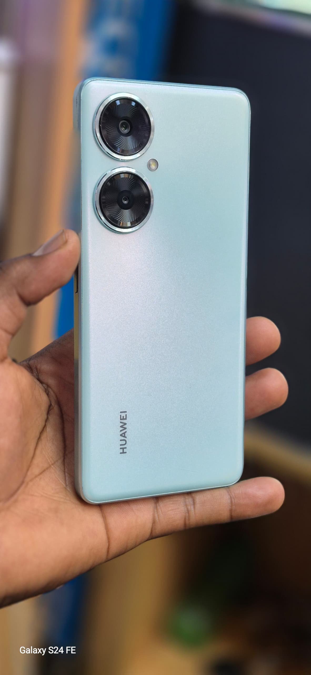 Huawei Nova 11i smartphone in a light green color
