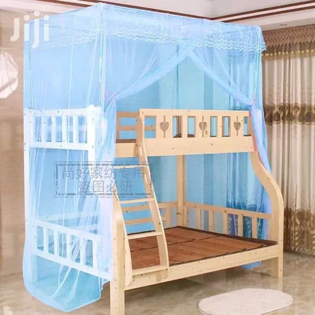 wooden bunk bed with a blue mosquito net