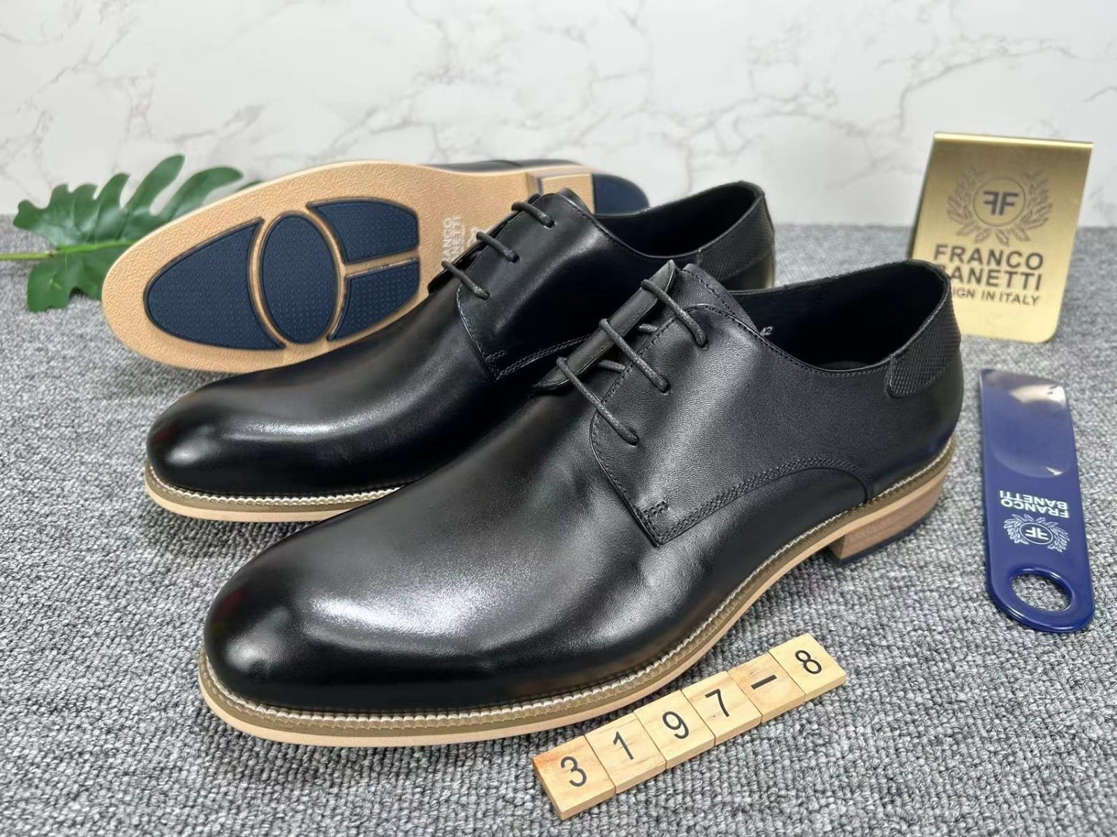 pair of men’s black leather lace-up shoes