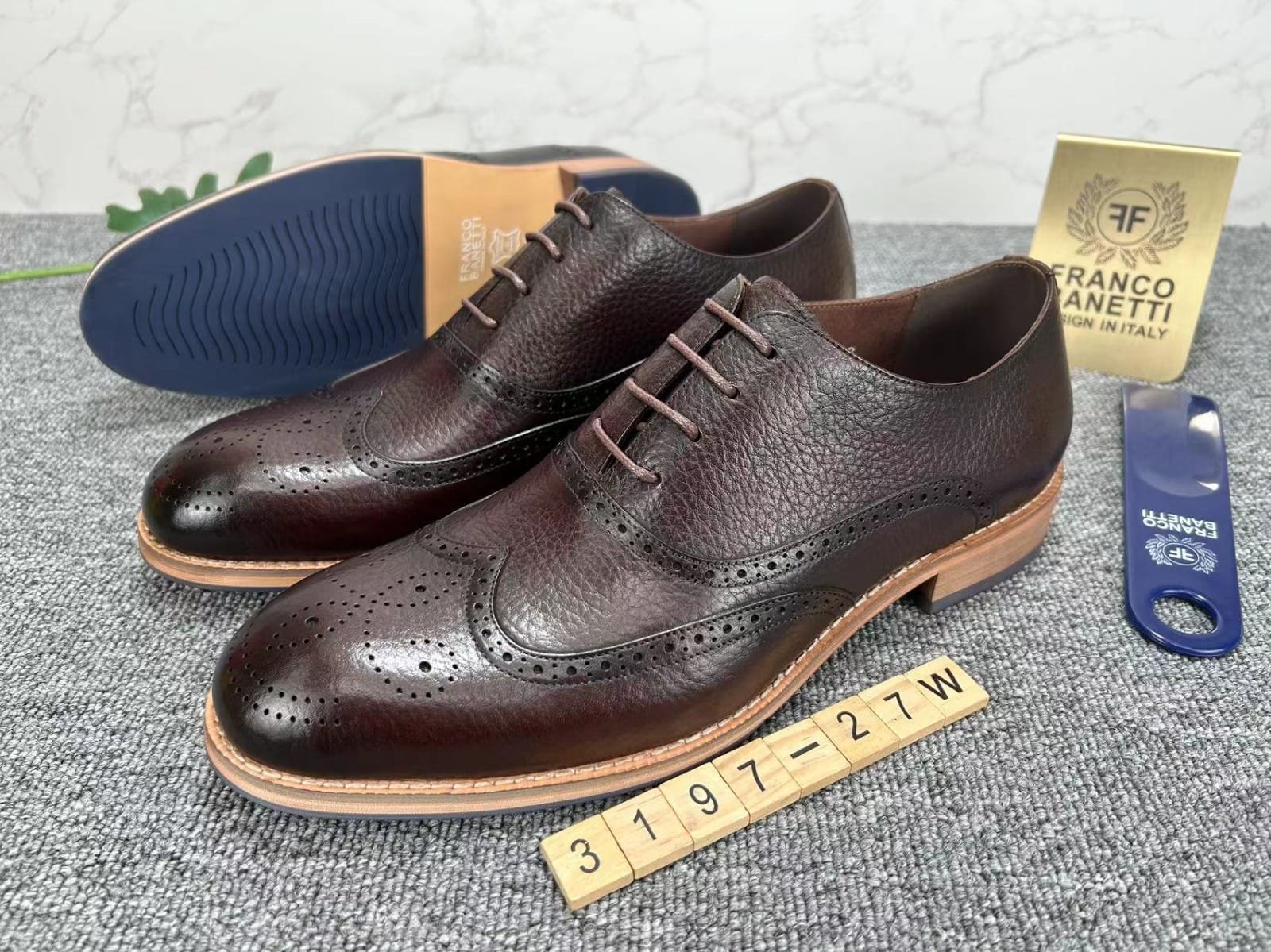 pair of men’s brown leather lace-up shoes