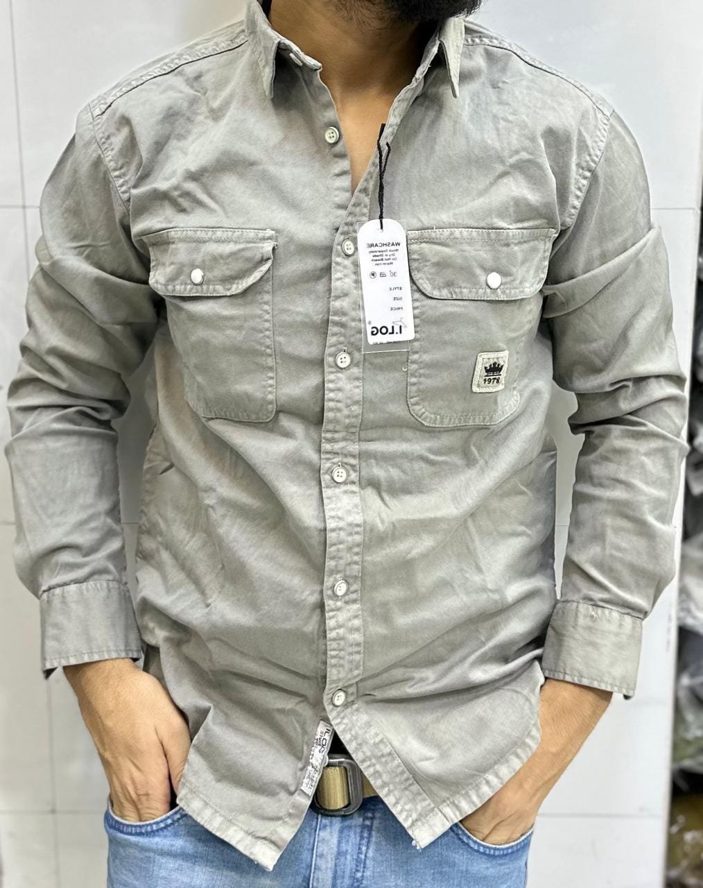 gray, long-sleeved button-down shirt