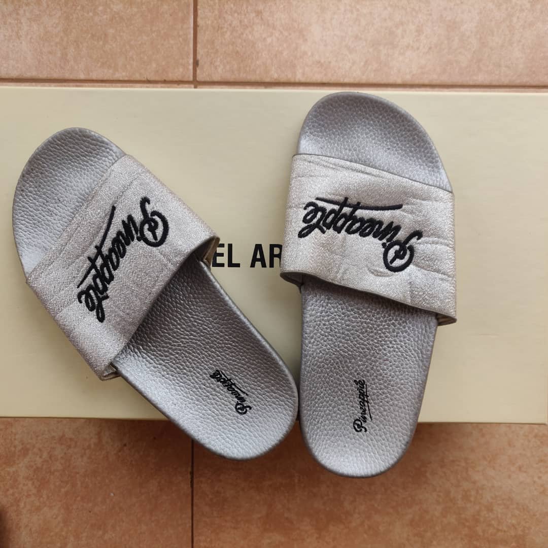silver-colored slide sandals