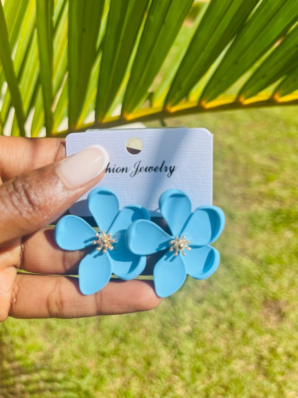 a pair of pink, petal-shaped dangle earrings
