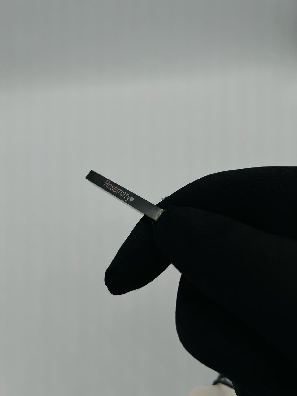 a silver-toned bar pendant