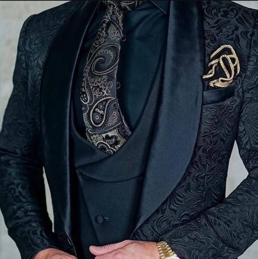 three-piece suit with a patterned black jacket,