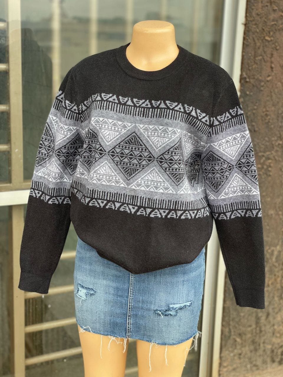 black and white speckled sweater with a denim mini skirt