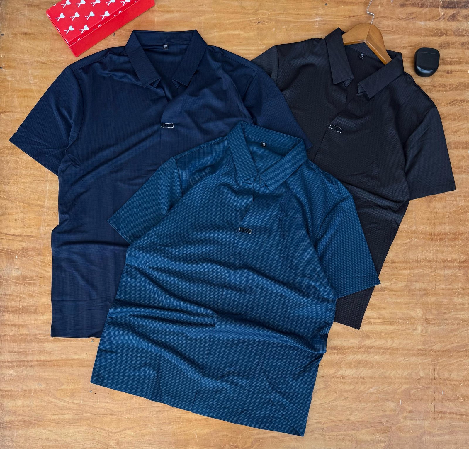 three men’s short-sleeved polo shirts