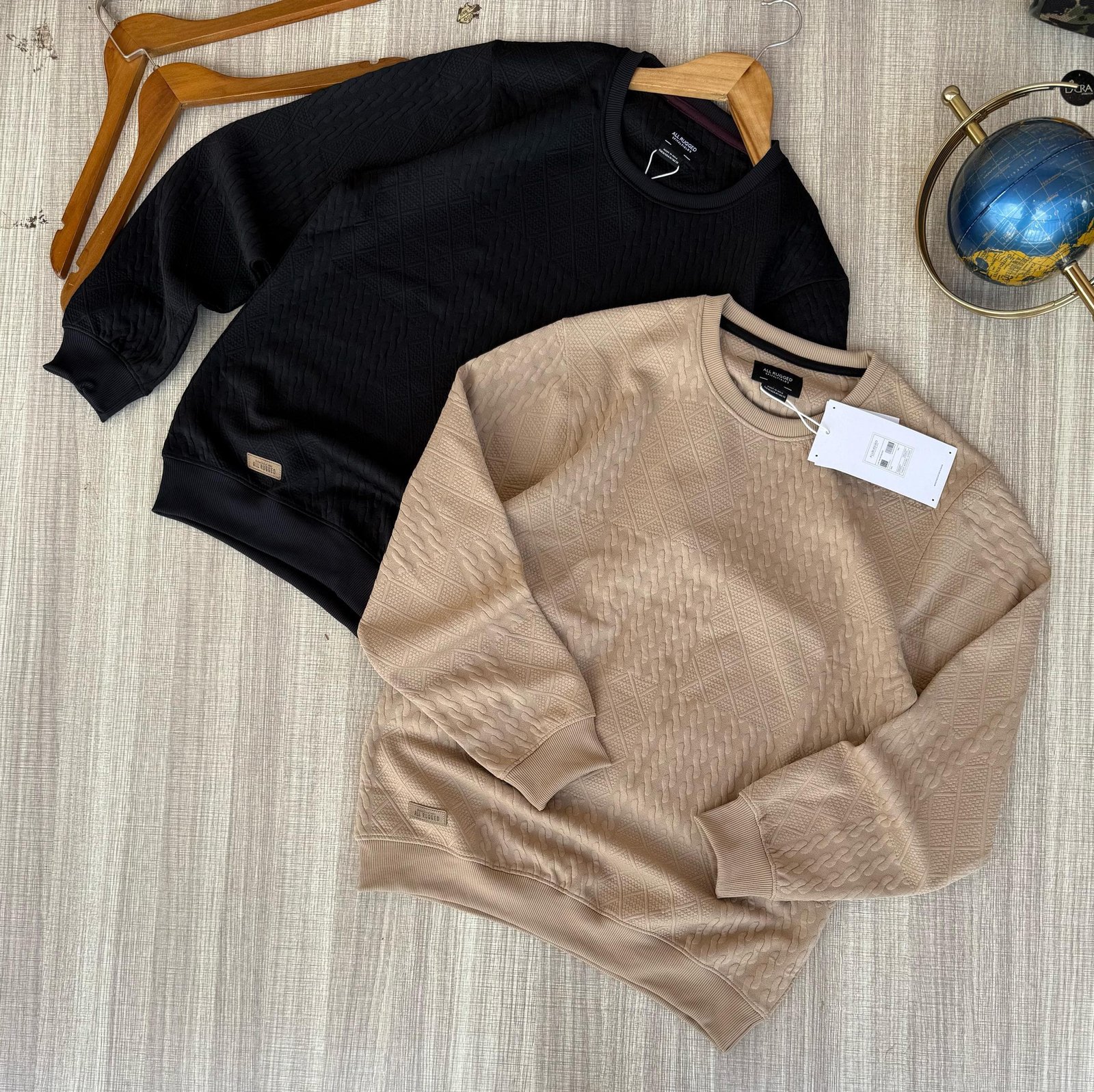 two men’s crewneck sweaters
