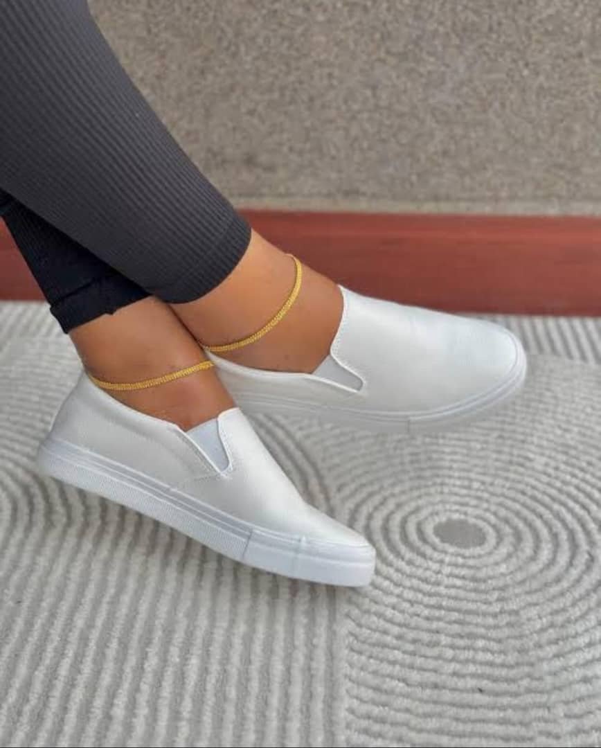 white slip-on sneakers.