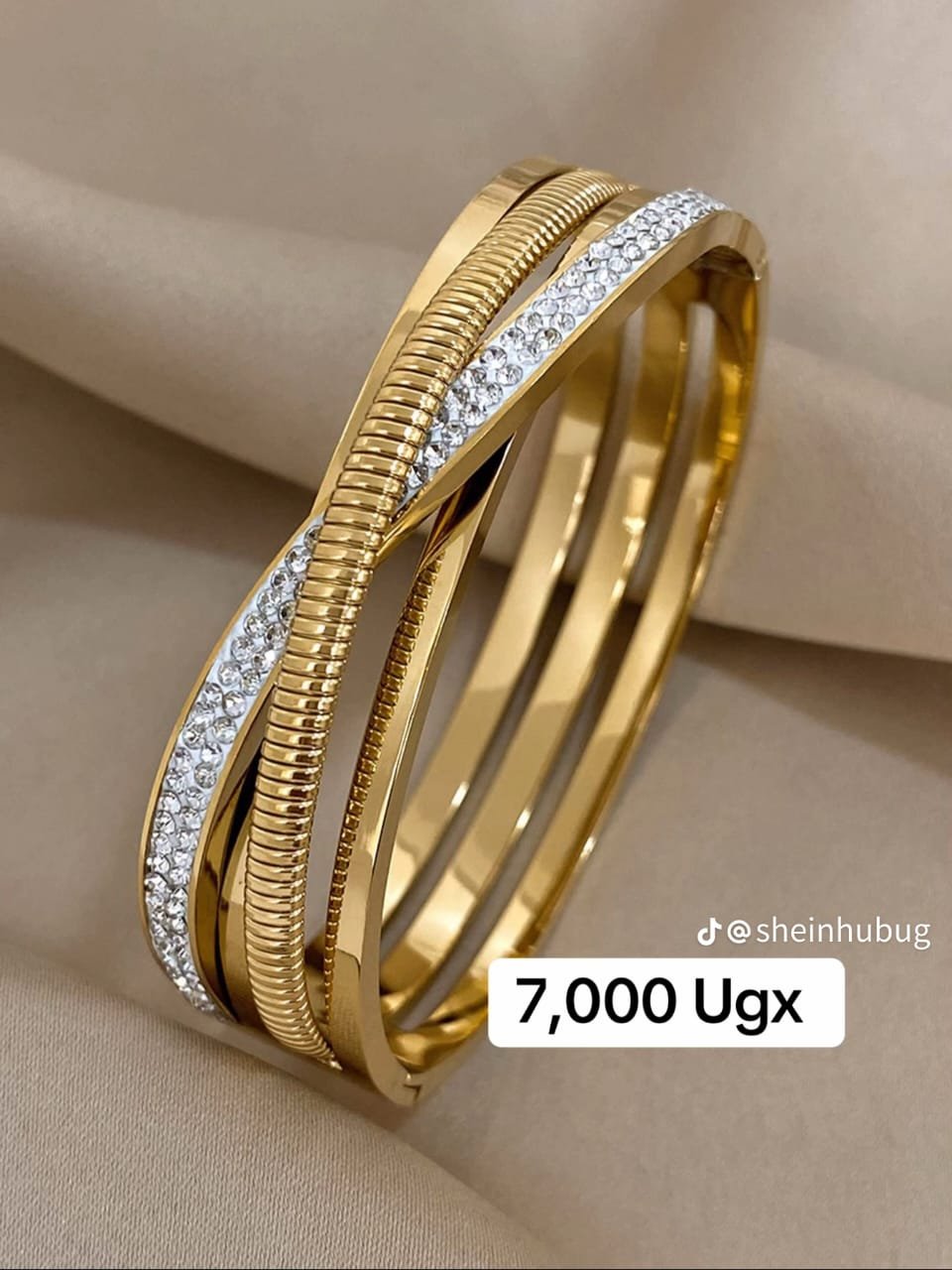 a gold-colored, stainless steel bangle