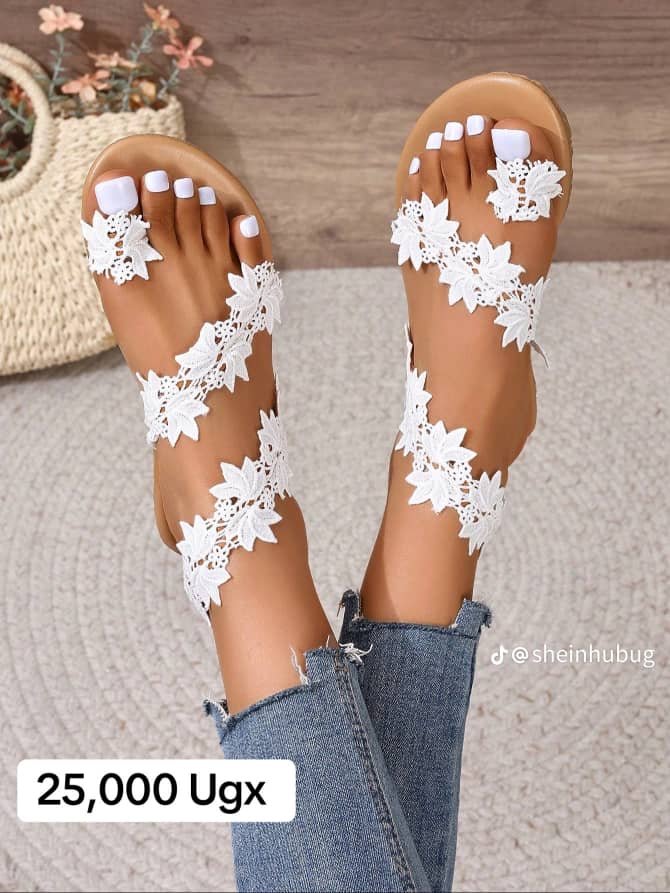 white flat sandals with floral lace appliques